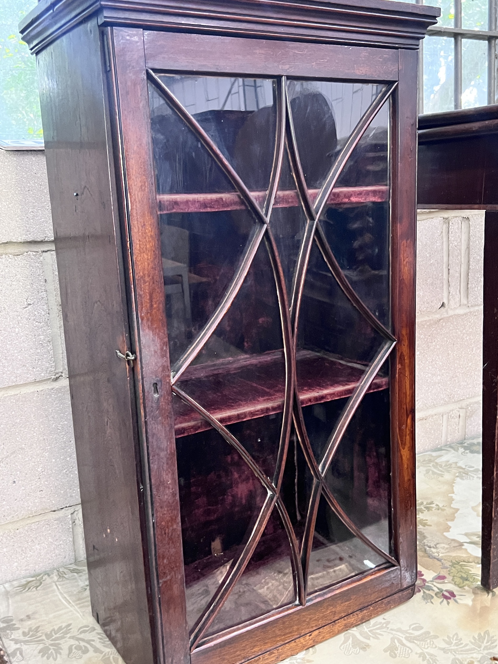 A small George III glazed mahogany hanging cupboard, height 85cm and a George III mahogany rectangular folding card table, width 80cm, depth 40cm, height 73cm (2)